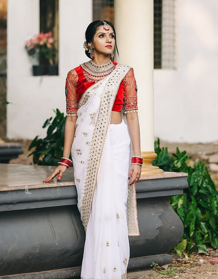 Shamatmika Devi Sreekumar in a white and gold saree